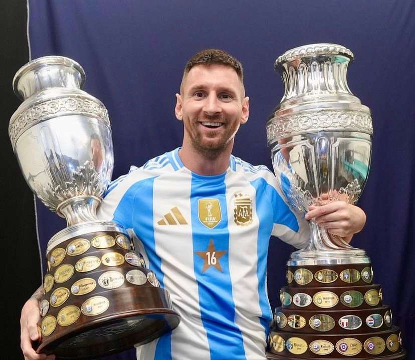 Lionel Messi with the COPA America trophies