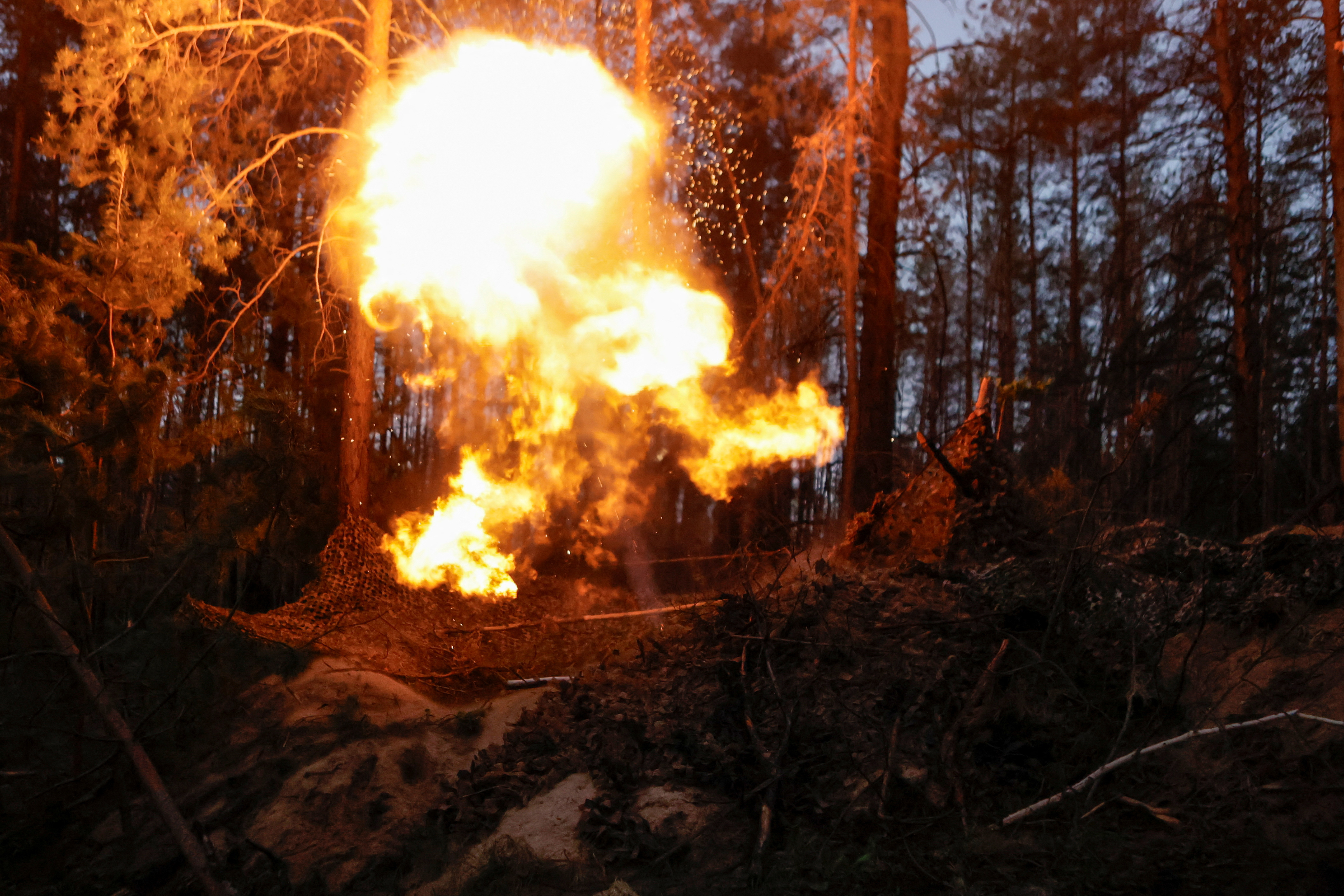 Ukrainian service members fire a mortar towards Russian troops, at a position in a front line in Donetsk region