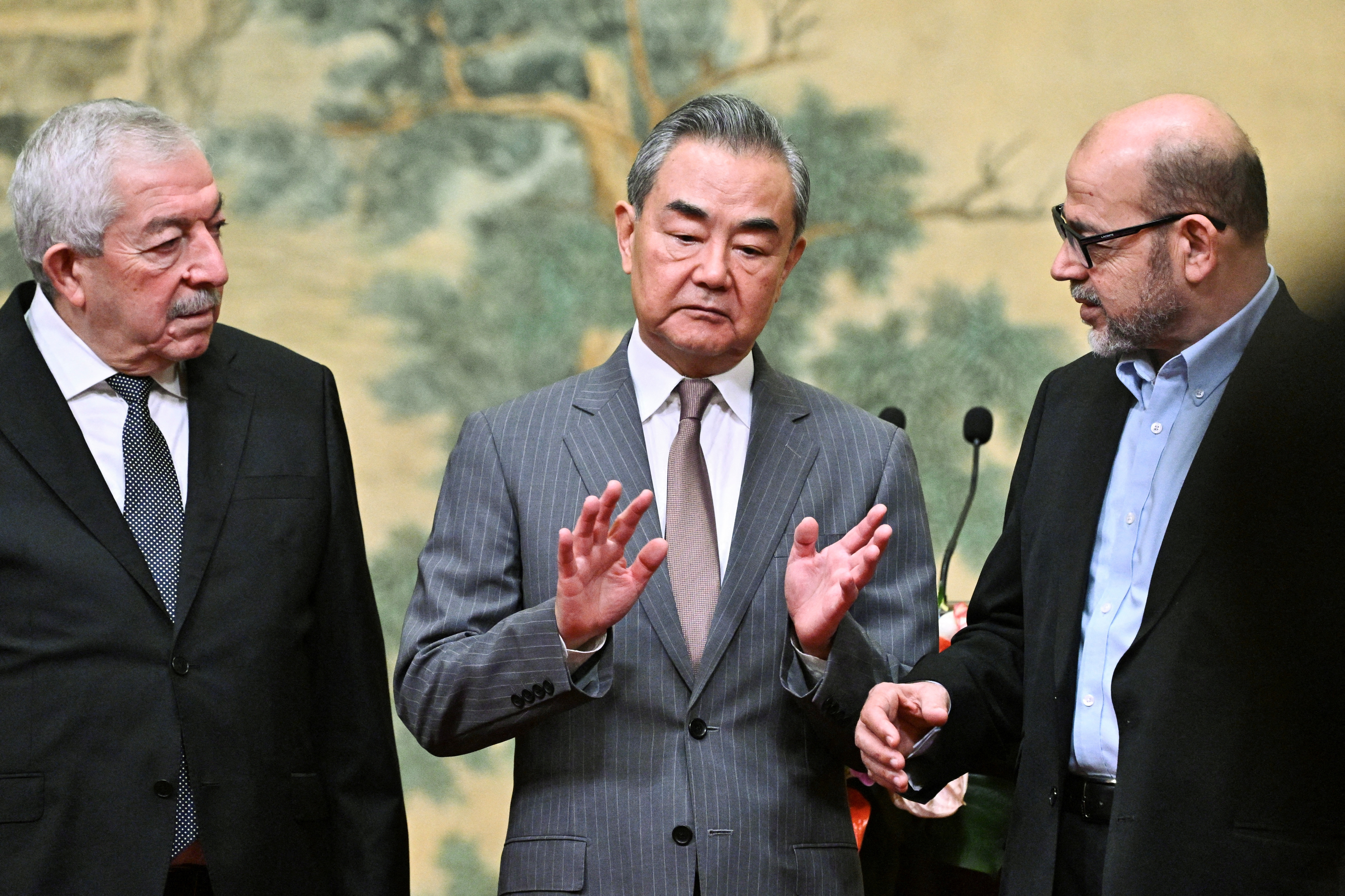 China's Foreign Minister Wang Yi hosts Vice Chairman of the Central Committee of Fatah, Mahmoud al-Aloul and senior member of Hamas, Mussa Abu Marzuk, at the Diaoyutai State Guesthouse in Beijing