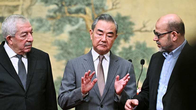 China's Foreign Minister Wang Yi hosts Vice Chairman of the Central Committee of Fatah, Mahmoud al-Aloul and senior member of Hamas, Mussa Abu Marzuk, at the Diaoyutai State Guesthouse in Beijing