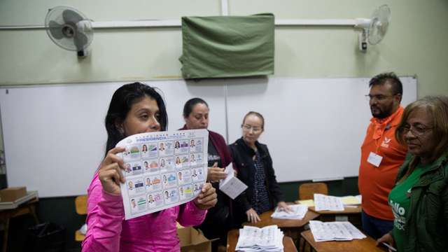 An electoral worker shows a ballot as they count ballots at a polling station during Costa Rica's general election, in San Jose, Costa Rica, February 1, 2026.