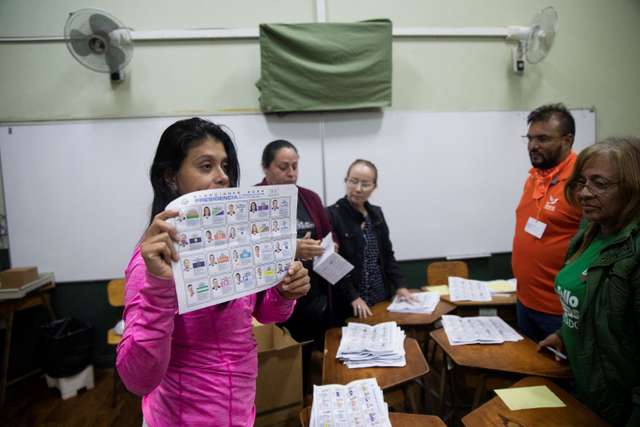 An electoral worker shows a ballot as they count ballots at a polling station during Costa Rica's general election, in San Jose, Costa Rica, February 1, 2026.