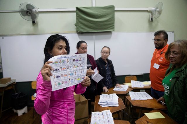 An electoral worker shows a ballot as they count ballots at a polling station during Costa Rica's general election, in San Jose, Costa Rica, February 1, 2026.