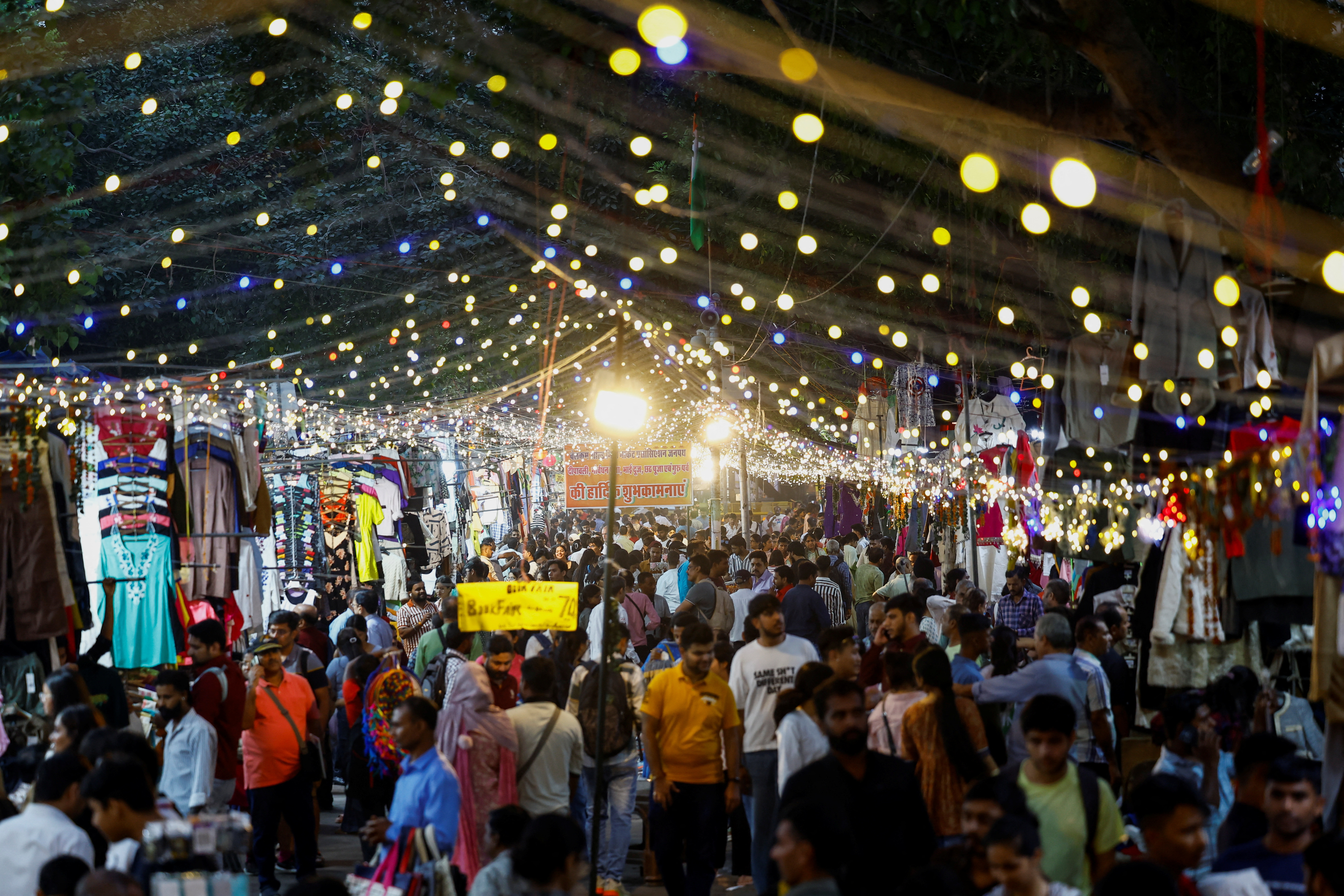 People shop at a market in New Delhi