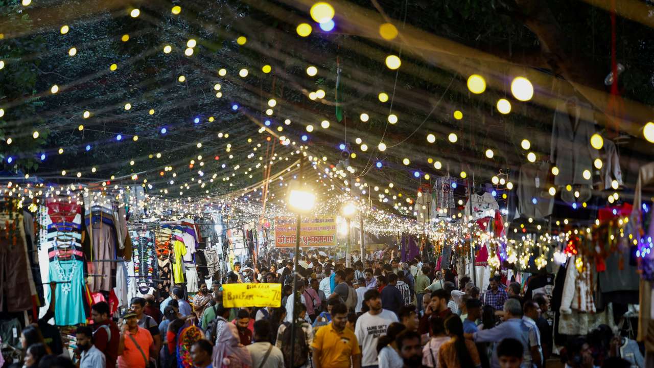 People shop at a market in New Delhi
