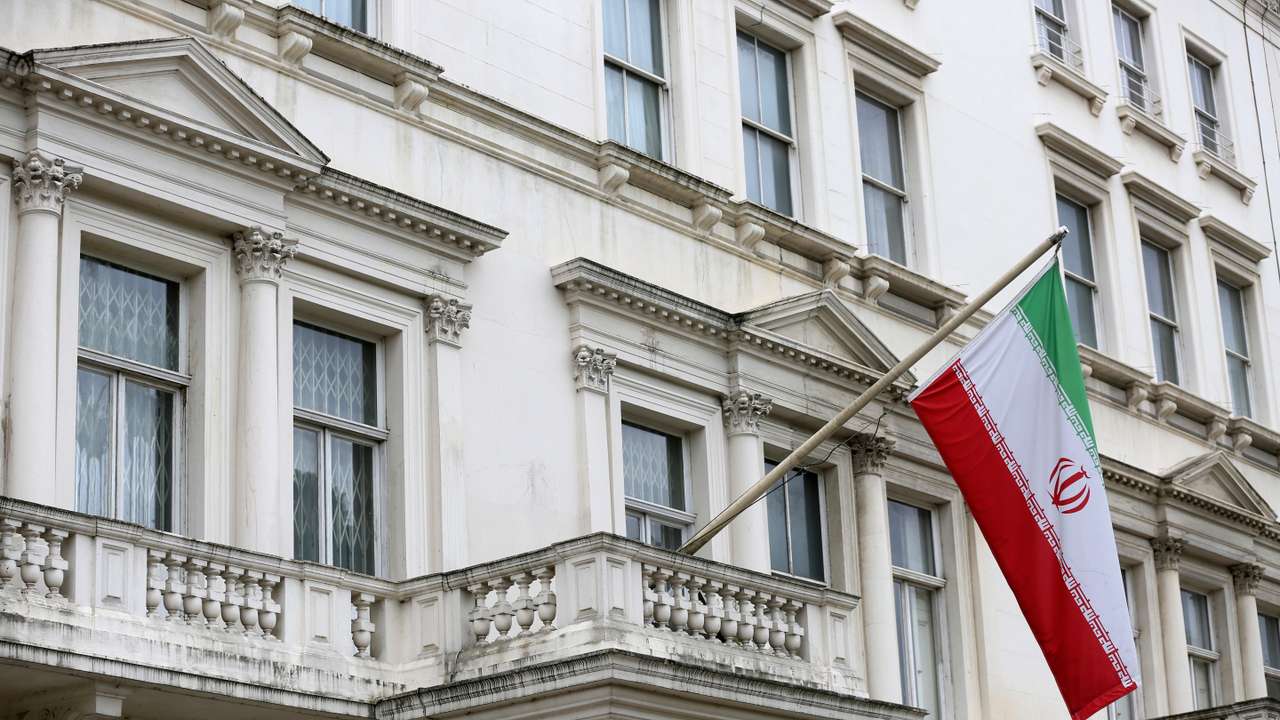 The Iranian national flag flies outside the Iranian embassy in central London