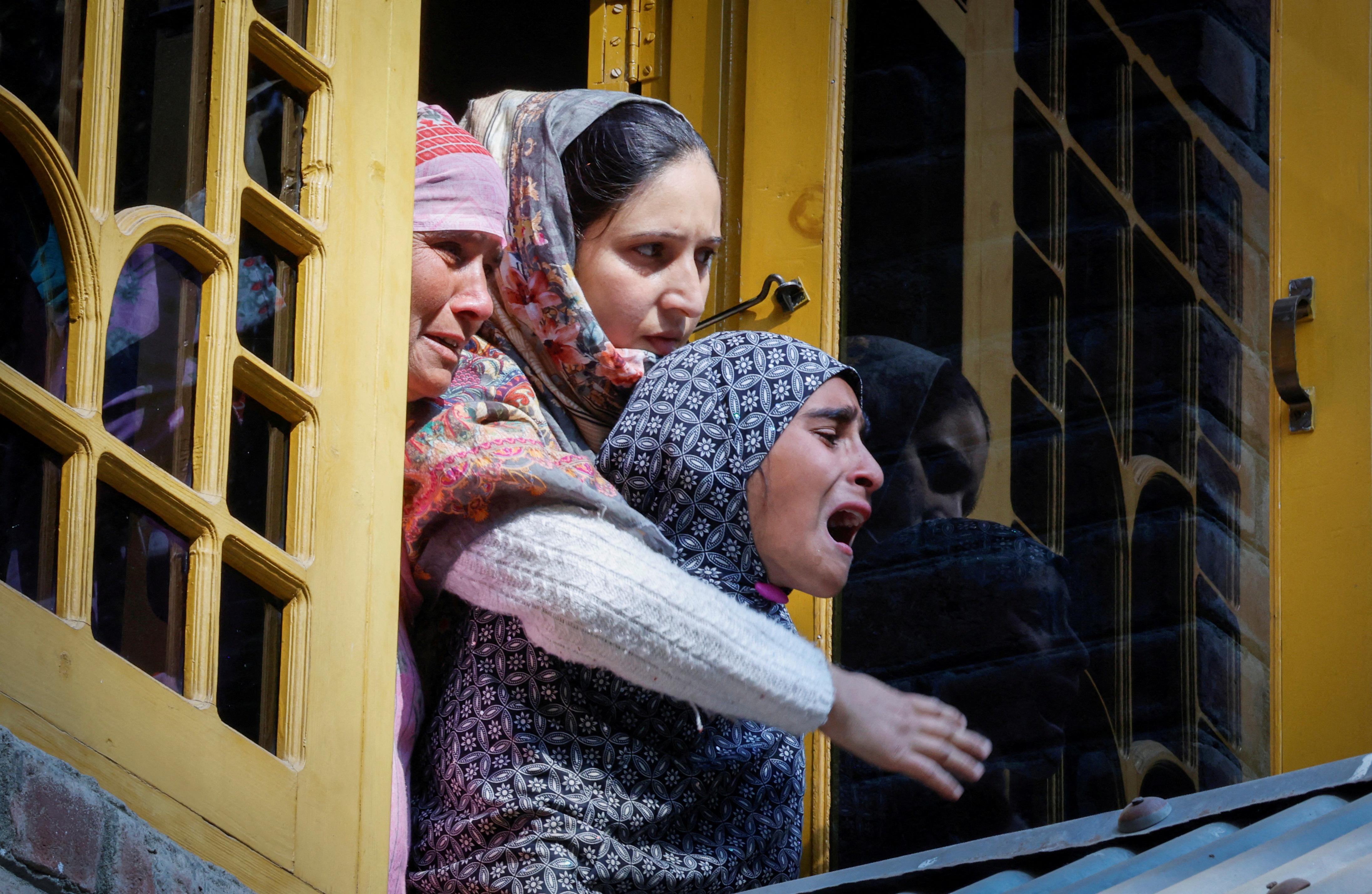 Women mourn Shahnawaz Dar, a doctor who was killed in a suspected militant attack at a tunnel construction site in Ganderbal's Gaganeer, during his funeral in Budgam