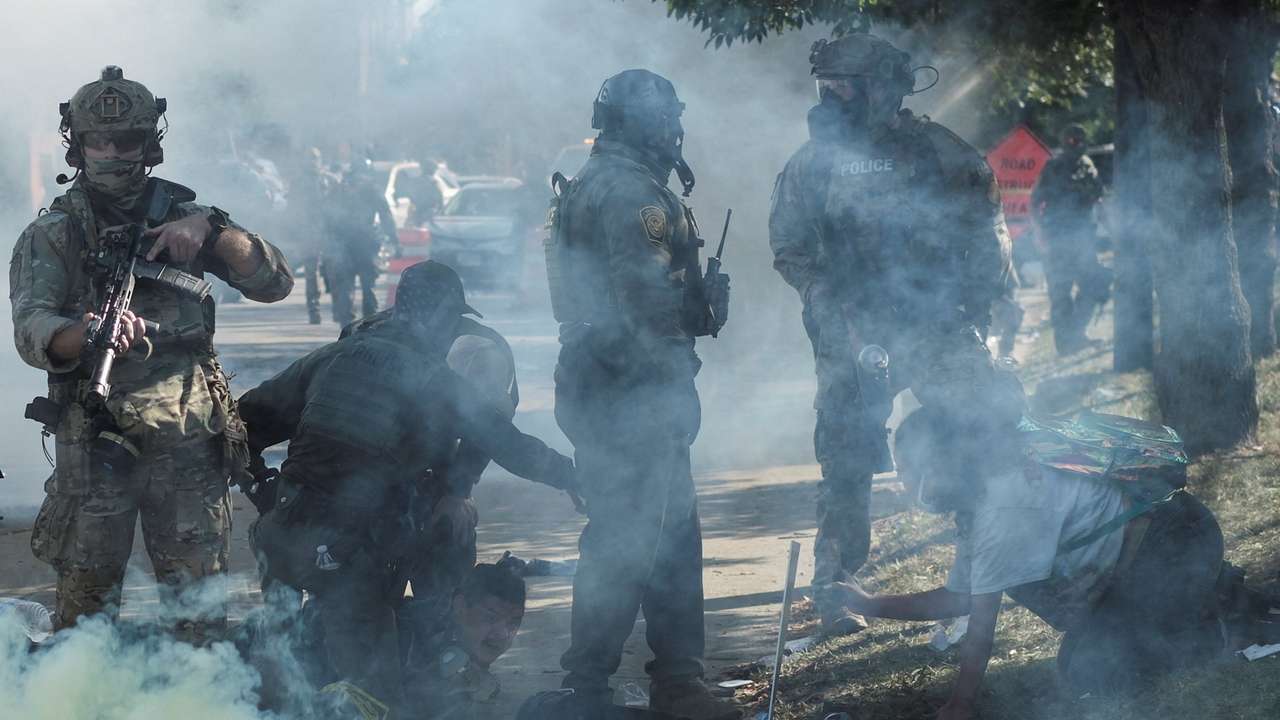 People protest during a standoff with ICE and federal officers in Chicago