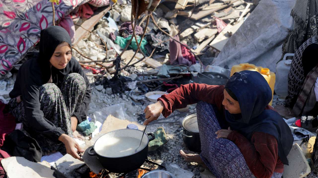 Palestinian mother, Manal al-Harsh, sits on rubble of her house destroyed during the Israeli offensive, amid a ceasefire between Israel and Hamas, in Jabalia refugee camp in the northern Gaza Strip