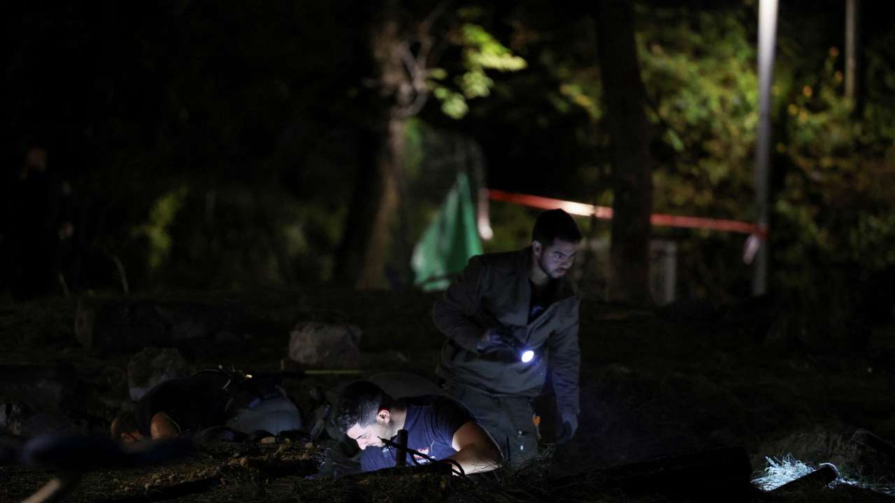 Israeli emergency services work at the scene of a missile strike, in Jaffa, south of Tel Aviv