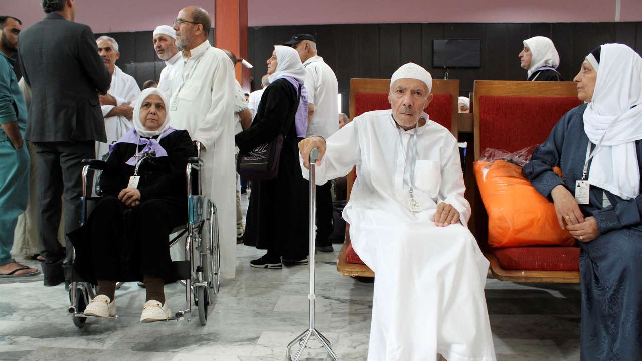 Syrian pilgrims wait to board a flight to Saudi Arabia at Damascus airport