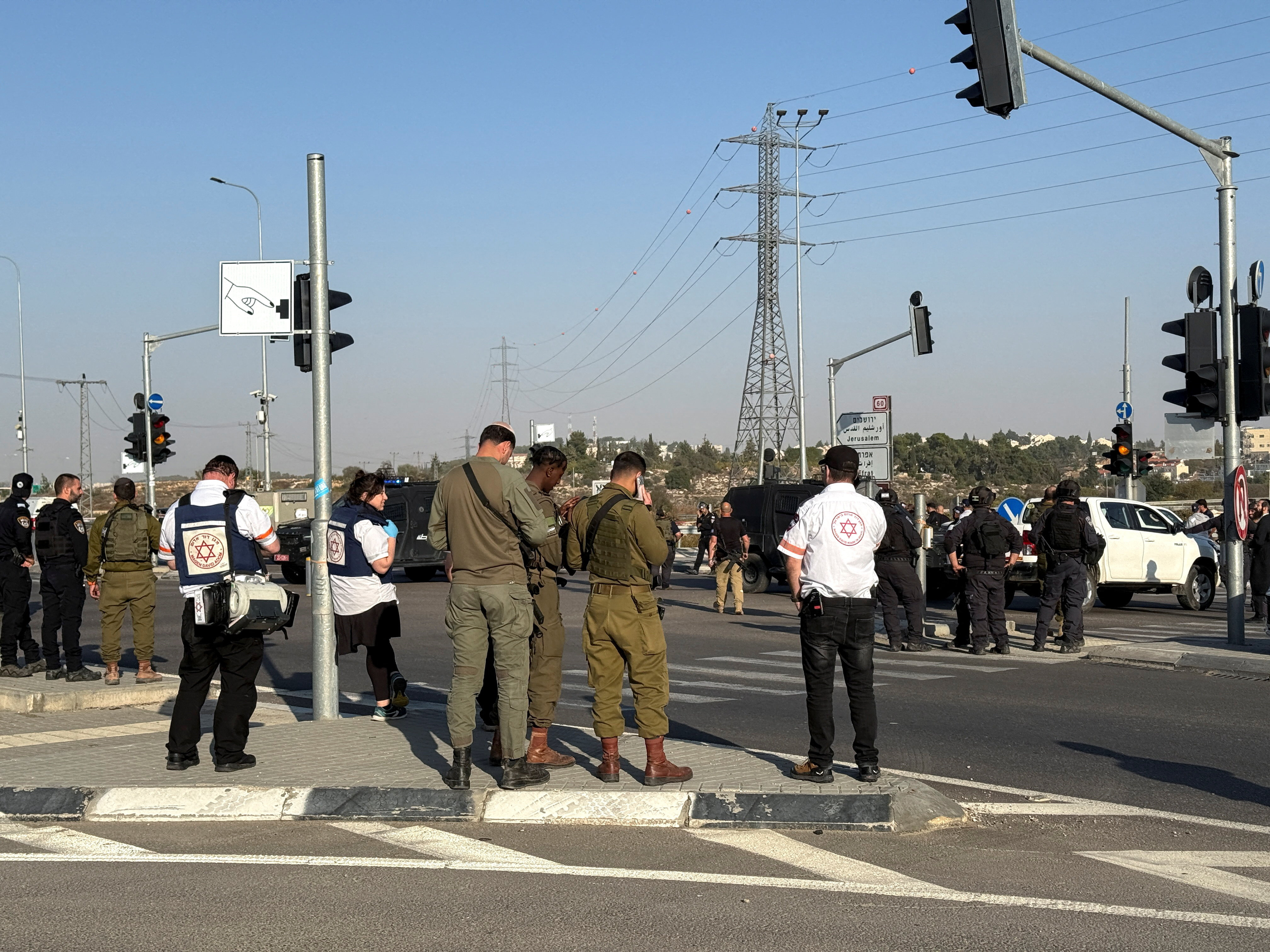 Israeli forces and emergency responders work at the scene of what Israel's ambulance services said was a fatal stabbing attack at the Gush Etzion junction in the Israeli-occupied West Bank