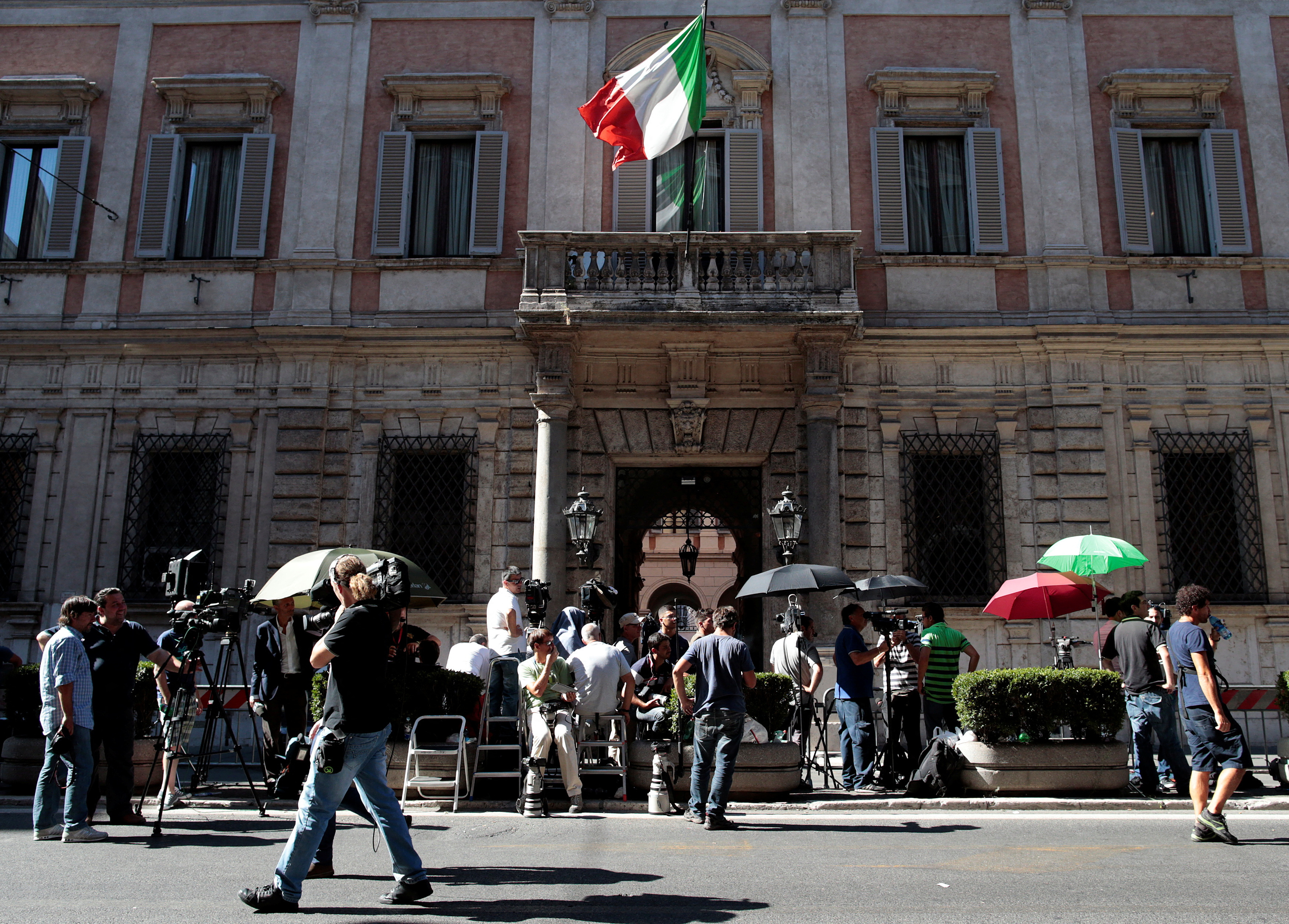 FILE PHOTO: Reporters wait in front of the Palazzo Grazioli, residence of former Italian Prime Minister Silvio Berlusconi, in Rome