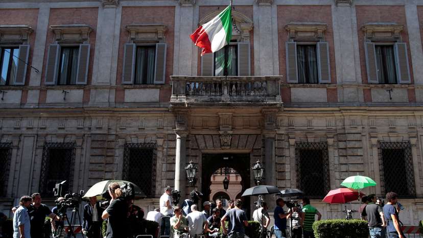 FILE PHOTO: Reporters wait in front of the Palazzo Grazioli, residence of former Italian Prime Minister Silvio Berlusconi, in Rome