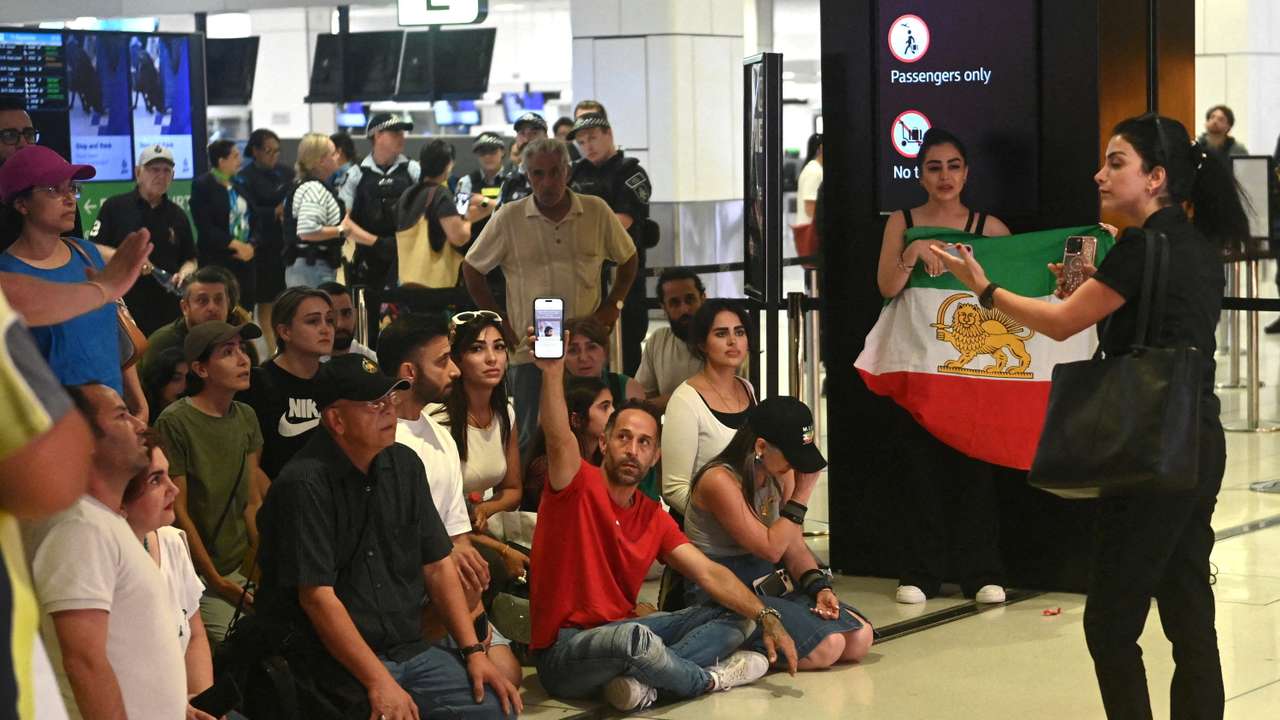 Supporters of the Iranian women's soccer team gather at Sydney Airport