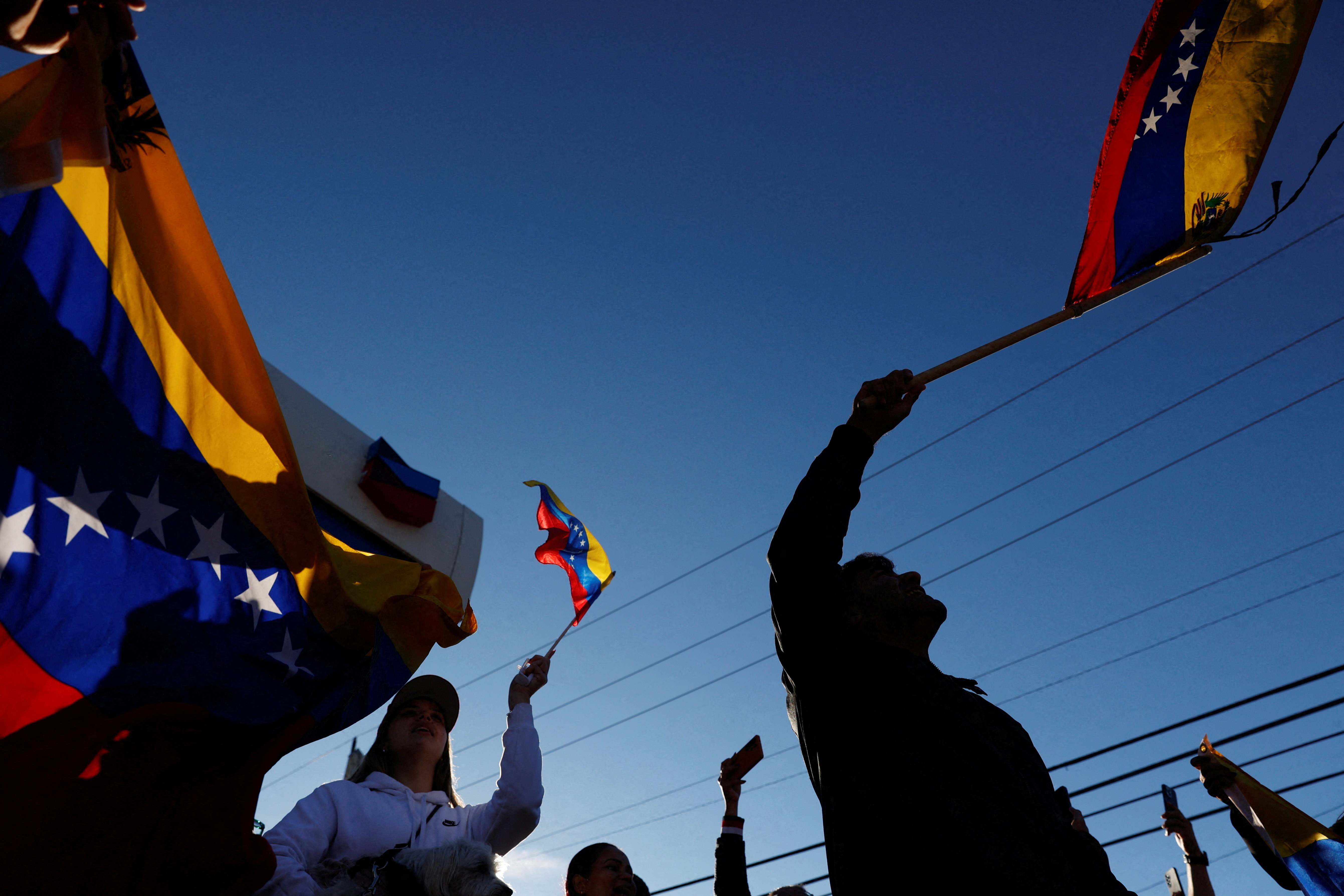 People wave Venezuelan flags and react to the news of U.S. strikes on Venezuela and capture of President Maduro, in Doral, Miami