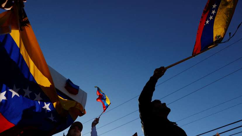 People wave Venezuelan flags and react to the news of U.S. strikes on Venezuela and capture of President Maduro, in Doral, Miami