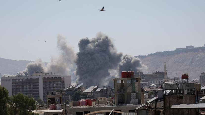 Smoke rises after strikes on Syria's defense ministry in Damascus