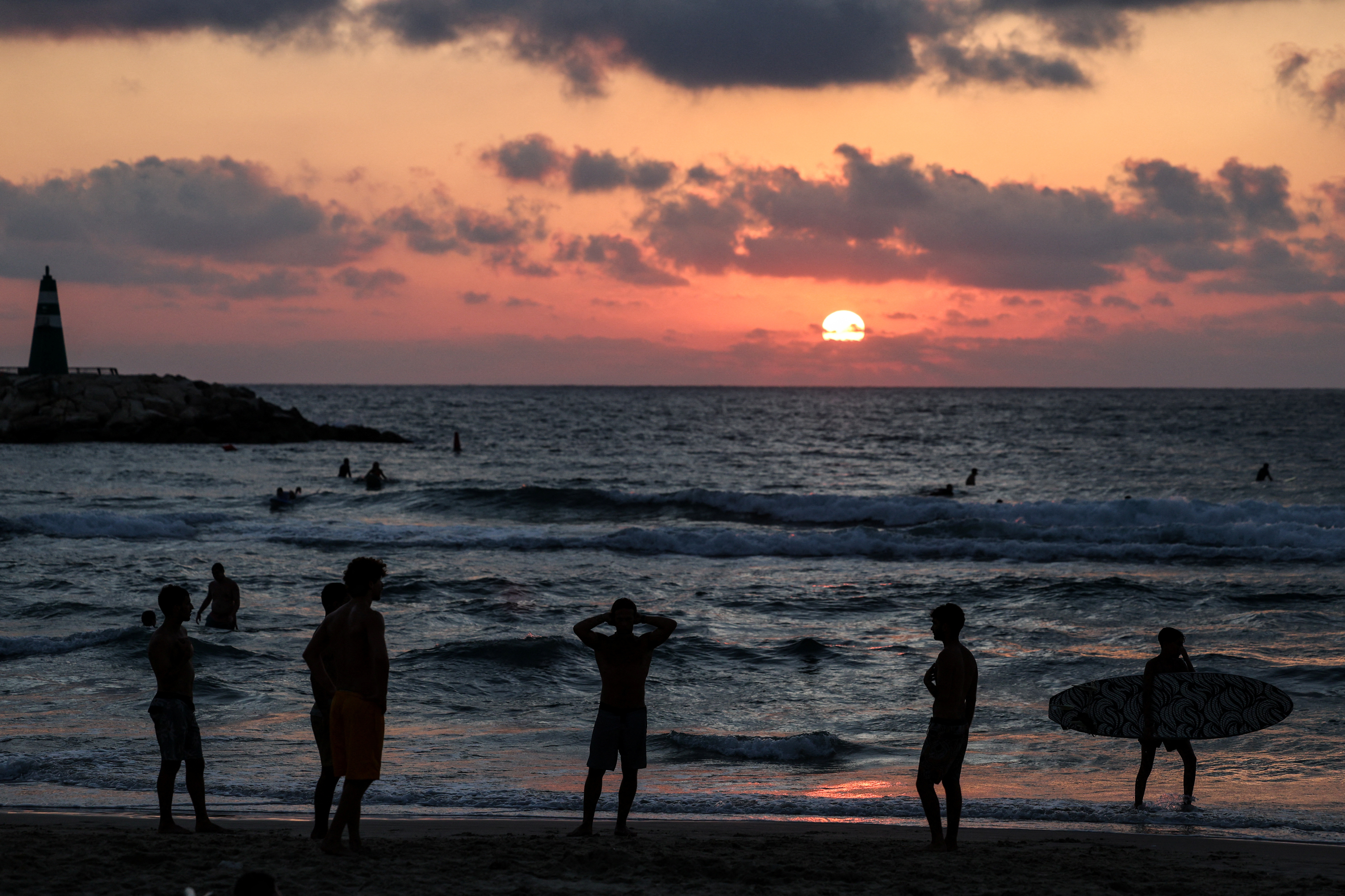 People spend time at the beach, after U.S. President Donald Trump announced a ceasefire between Israel and Iran, in Tel Aviv
