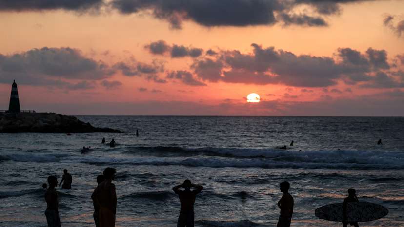 People spend time at the beach, after U.S. President Donald Trump announced a ceasefire between Israel and Iran, in Tel Aviv