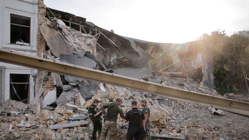 Investigators inspect the site of the Russian missile strike, in Kyiv