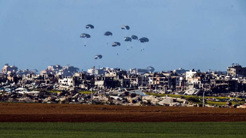 FILE PHOTO: Packages dropped from a military aircraft fall towards northern Gaza, as seen from Israel