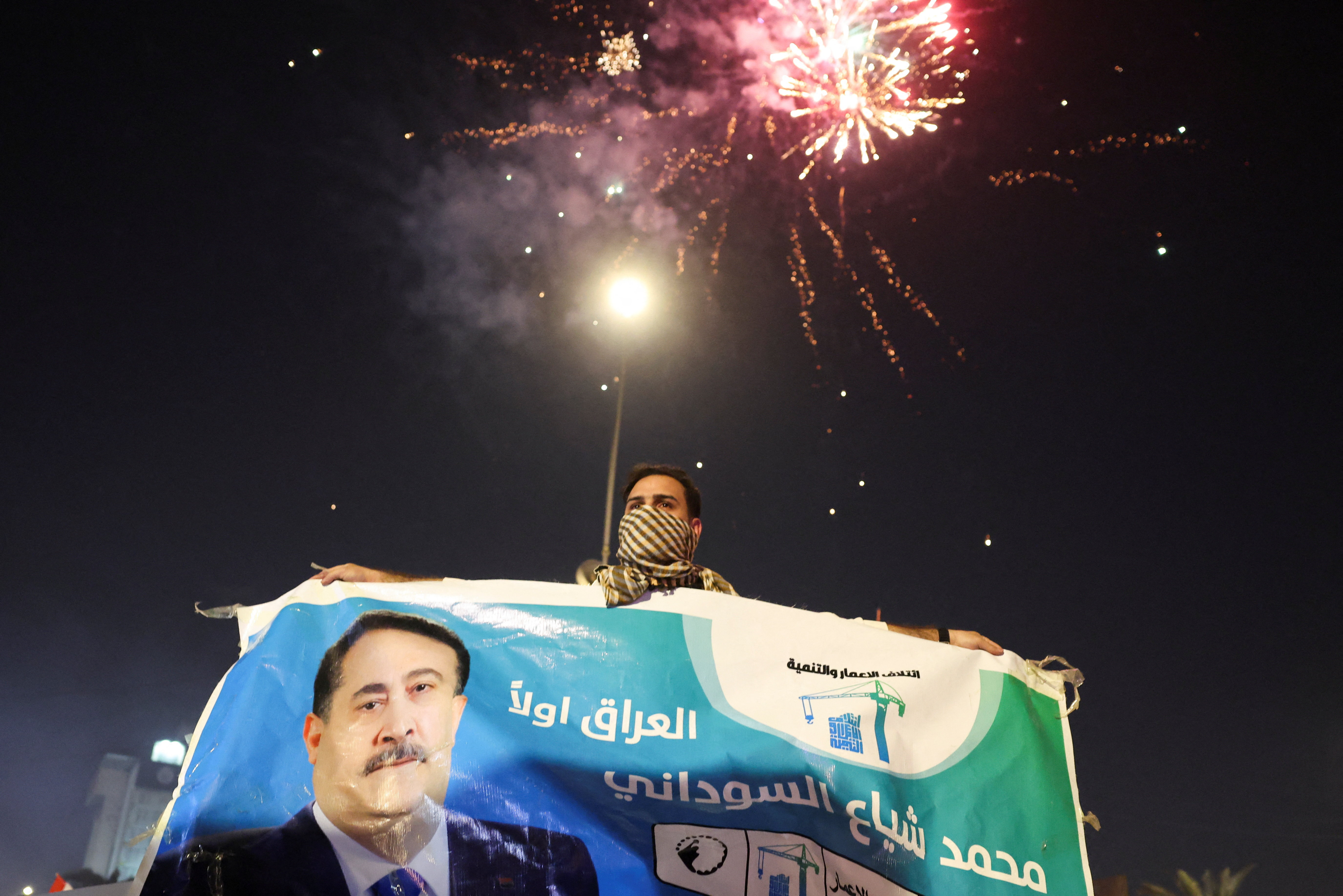 Supporters of the Reconstruction and Development Coalition celebrate after preliminary election results were announced in Baghdad