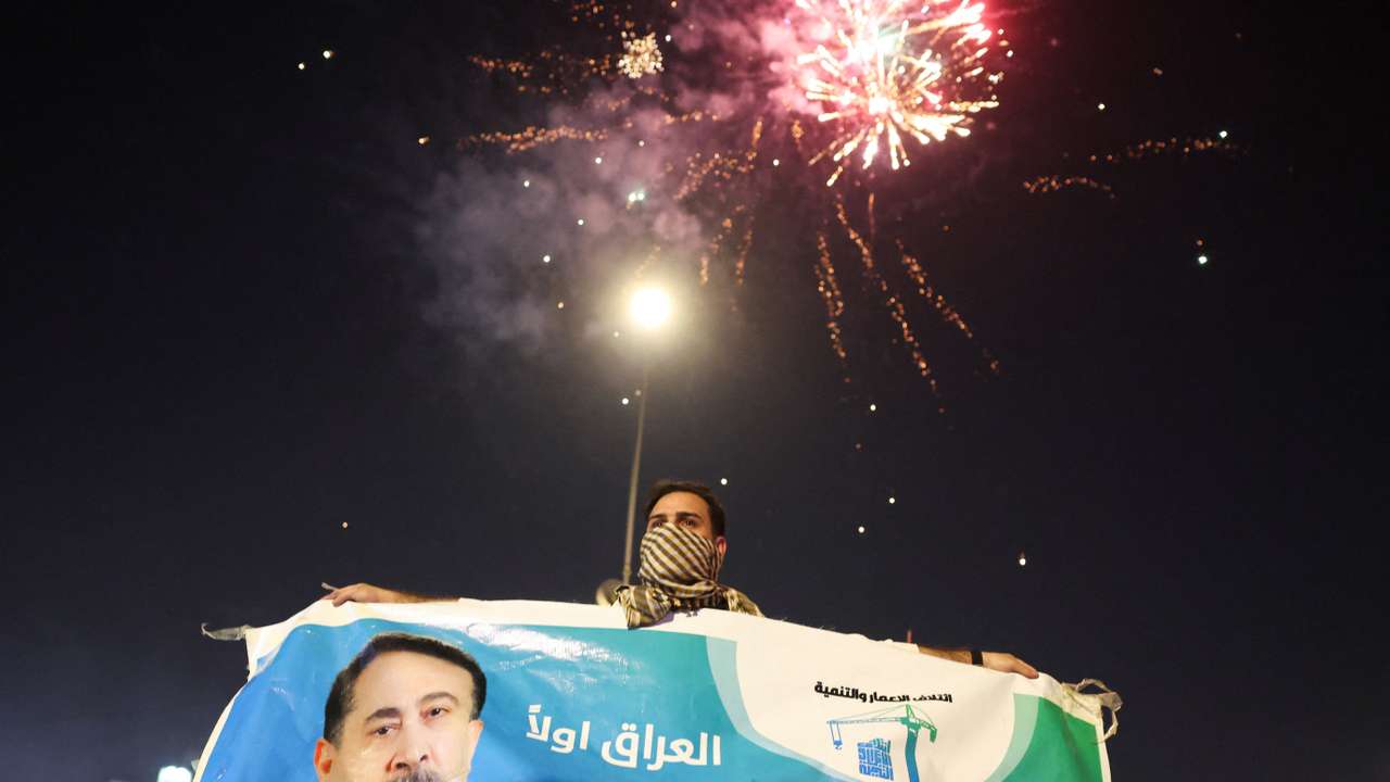 Supporters of the Reconstruction and Development Coalition celebrate after preliminary election results were announced in Baghdad
