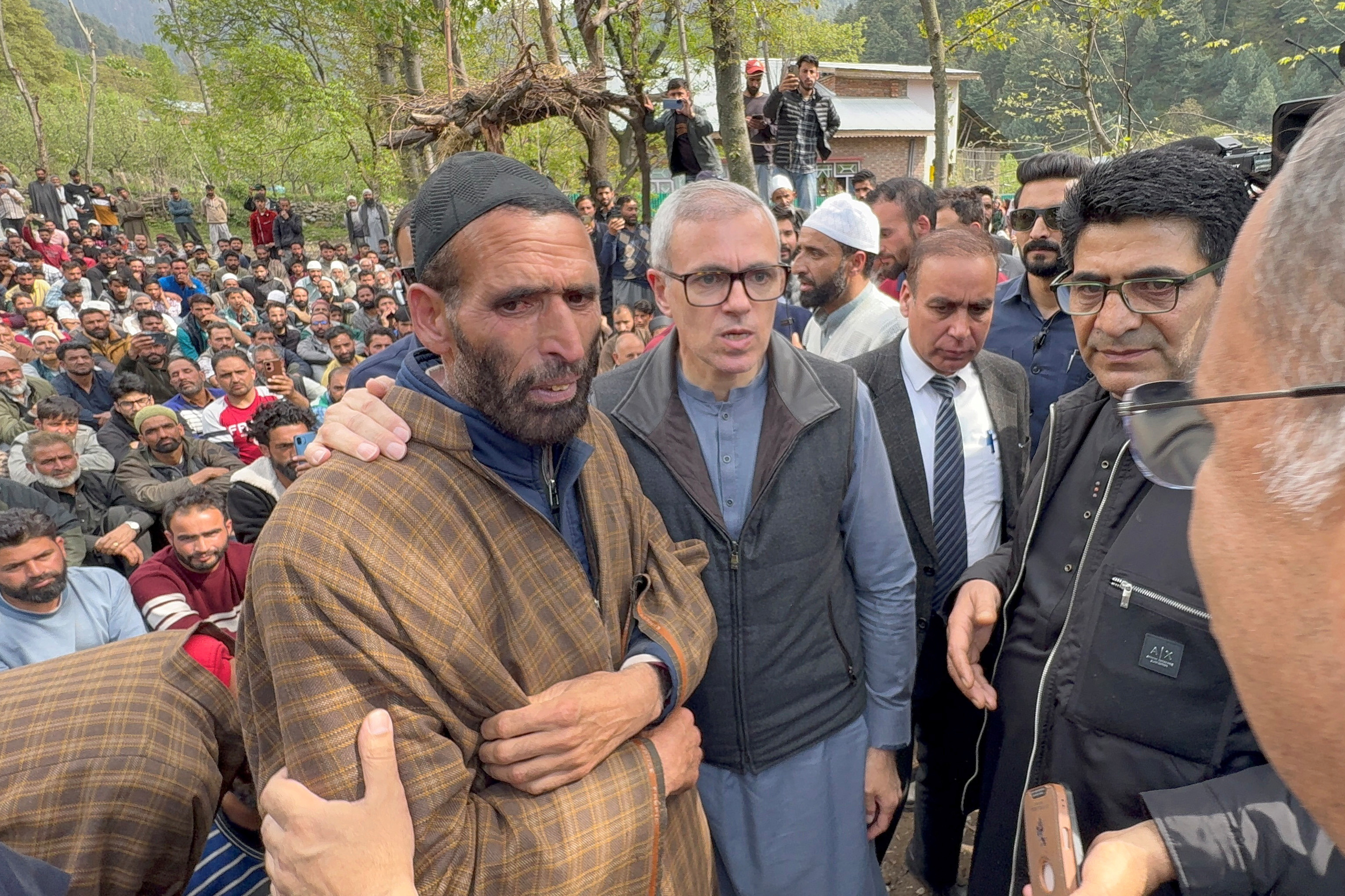 Omar Abdullah, Chief Minister of Jammu and Kashmir, consoles the father of Adil Hussain Shah who was killed in a suspected militant attack near Pahalgam, before the funeral prayers in Hapatnard