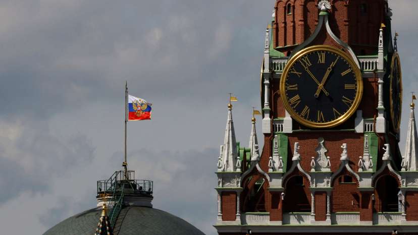 The Russian flag flies on the dome of the Kremlin Senate building in Moscow