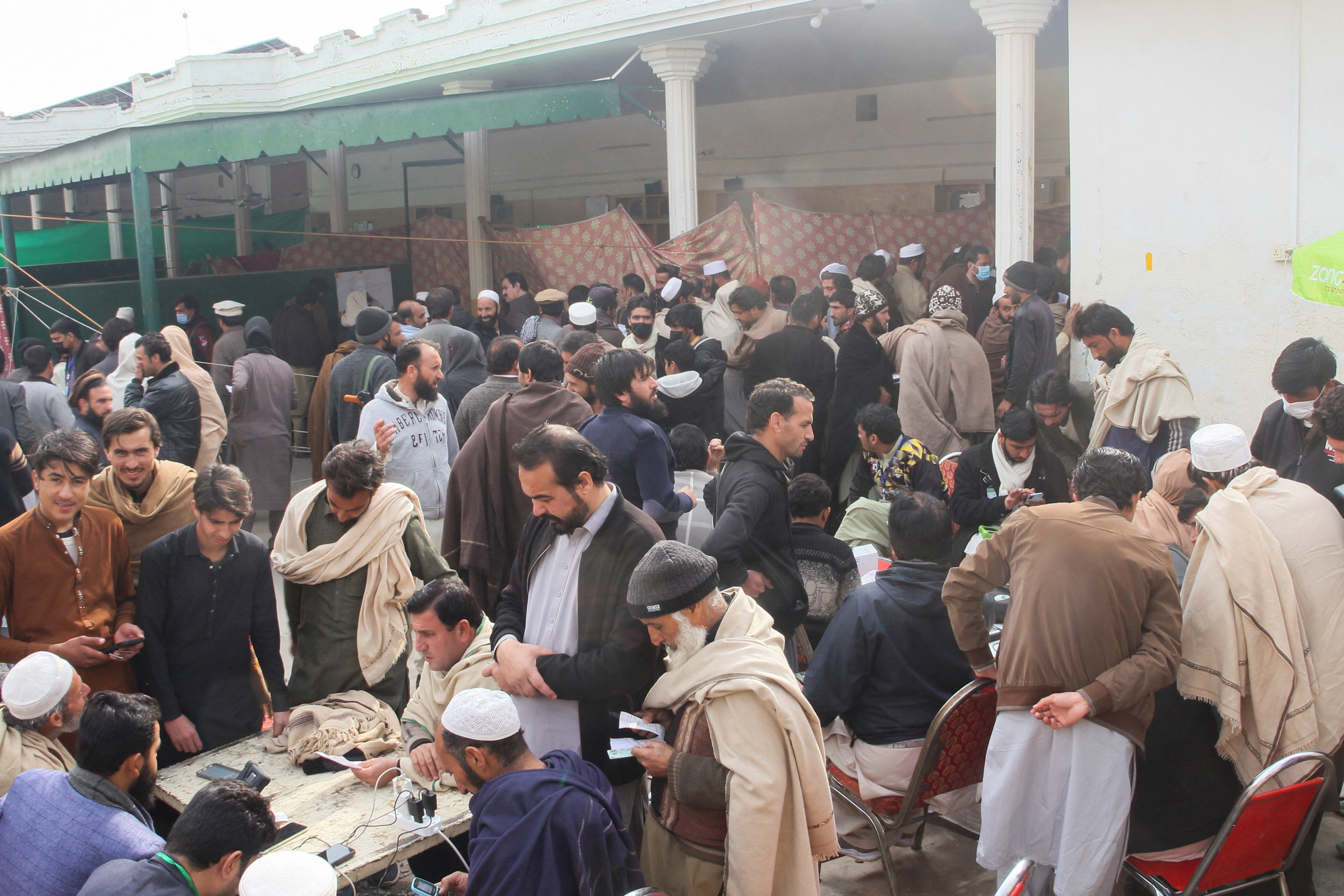 Residents from Tirah valley, who fled a remote mountainous region bordering Afghanistan, gather to get themself registered, in Bara
