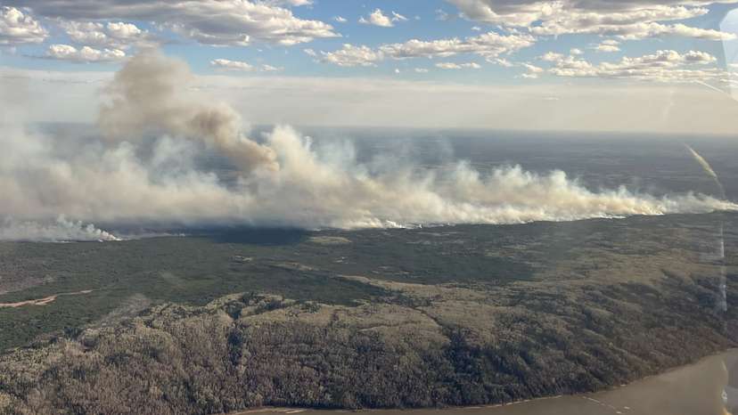 Smoke rises from wildfire MWF017 on the south side of the Athabasca River valley near Fort McMurray
