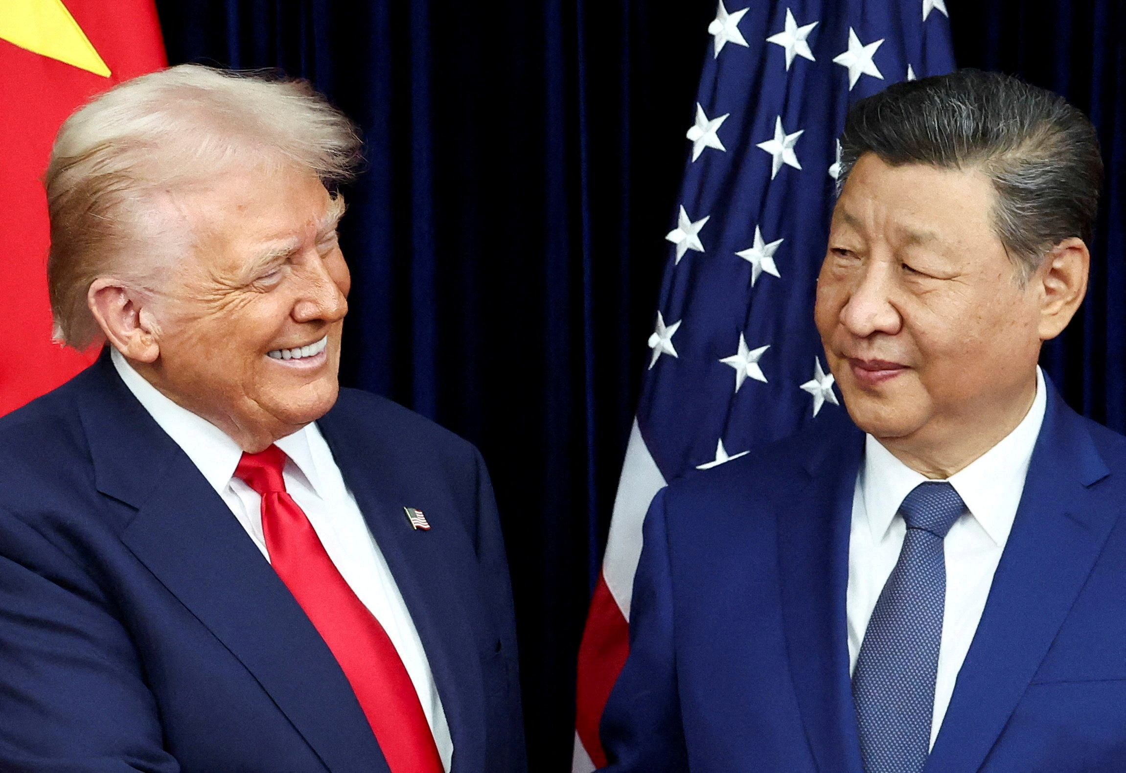 FILE PHOTO: U.S. President Donald Trump meets with Chinese President Xi Jinping on the sidelines of the APEC summit, in Busan