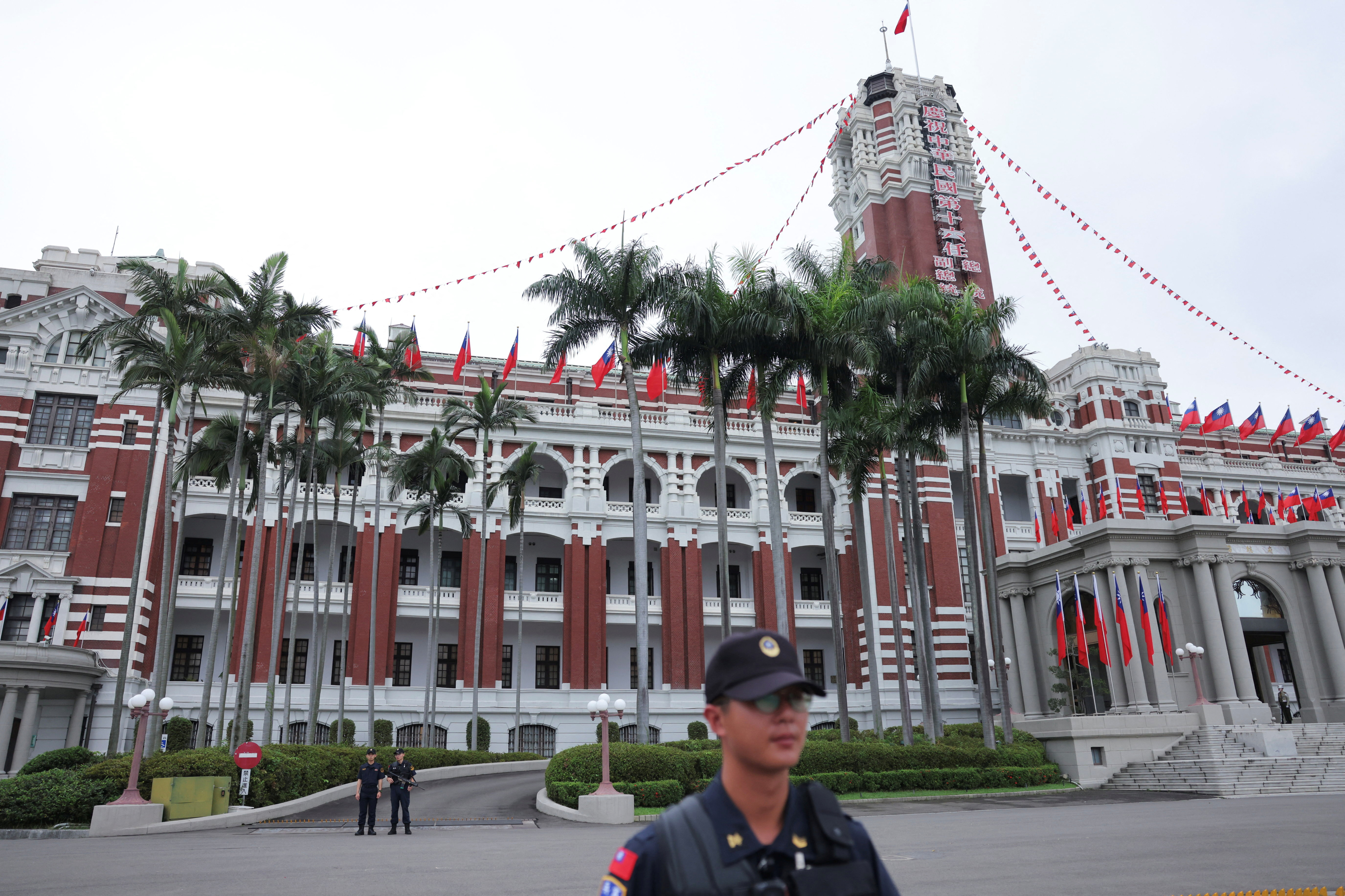 Security guards stand guard in front of the Presidential Office Building, in Taipei