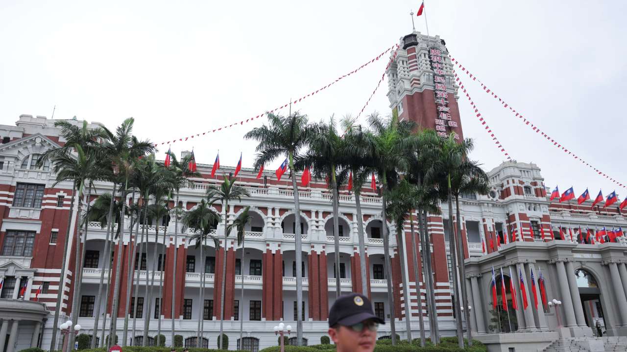 Security guards stand guard in front of the Presidential Office Building, in Taipei