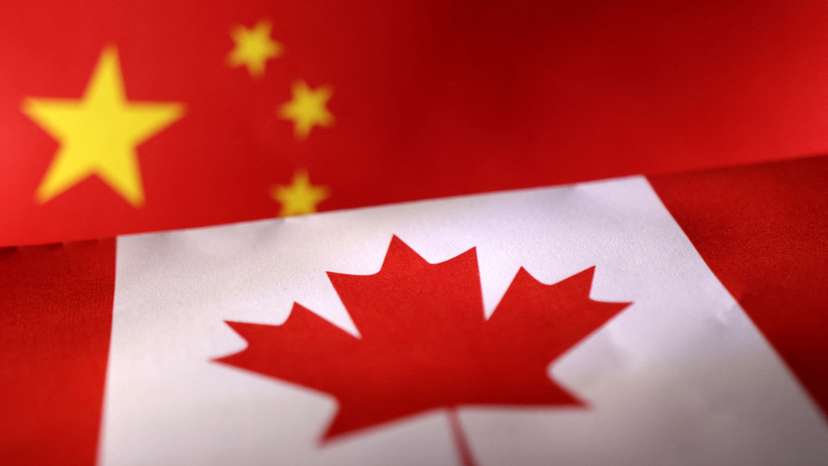 Illustration shows printed Chinese and Canada flags