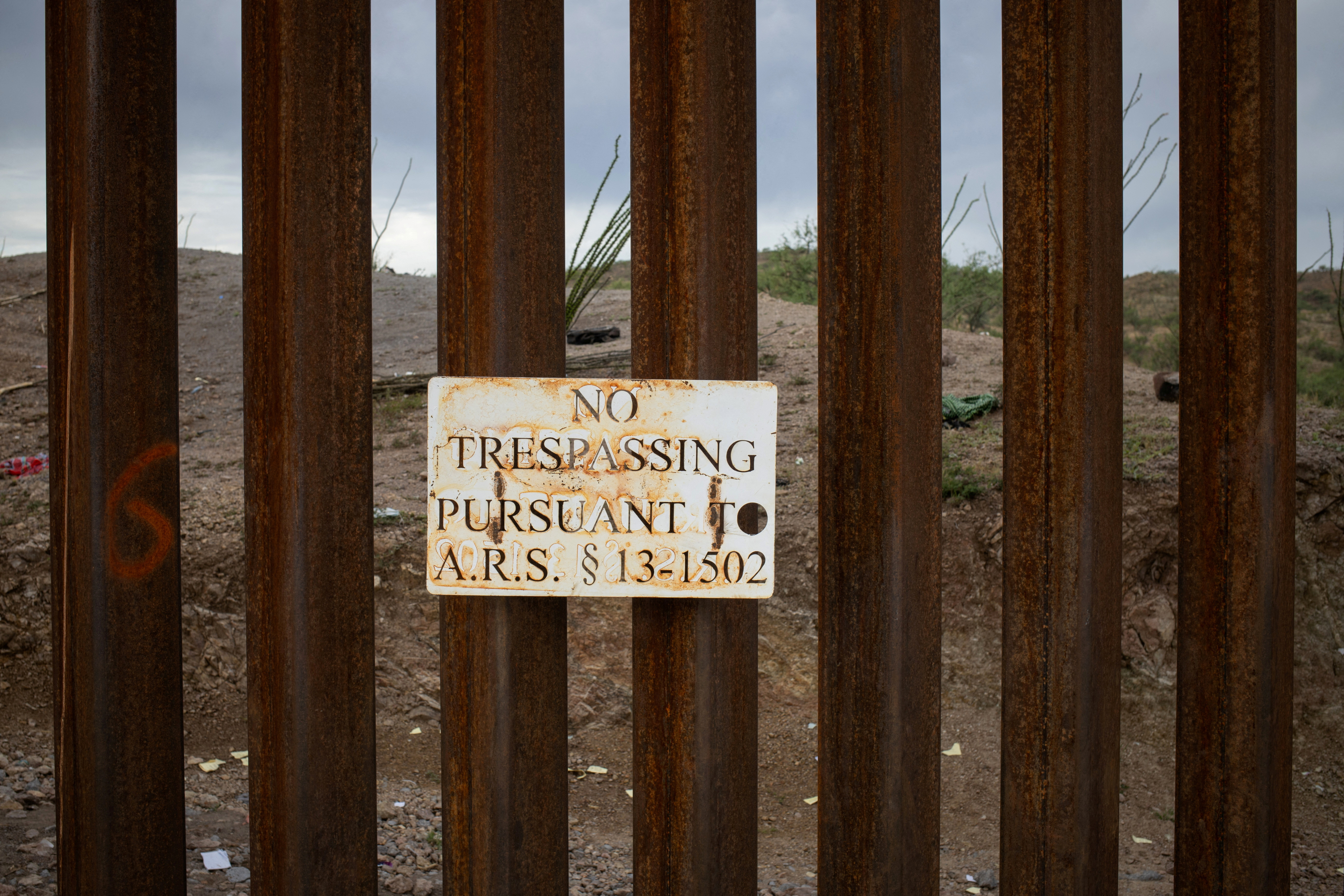 FILE PHOTO: "No Trespassing," sign is seen attached along the Border Wall in Ruby, Arizona,