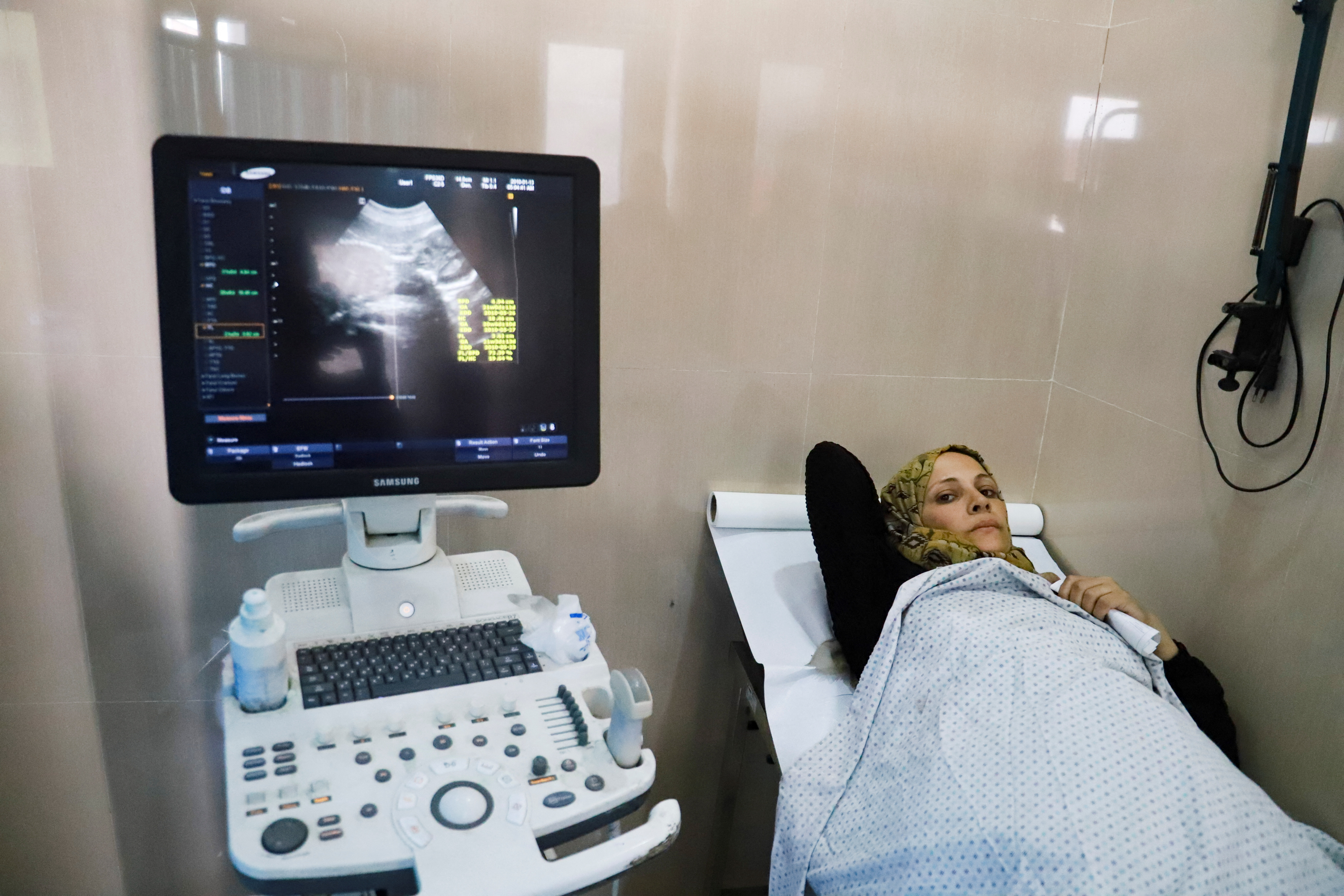 Fatima Arafa, a pregnant and displaced Palestinian woman, undergoes medical check up at Al-Helou hospital, in Gaza City