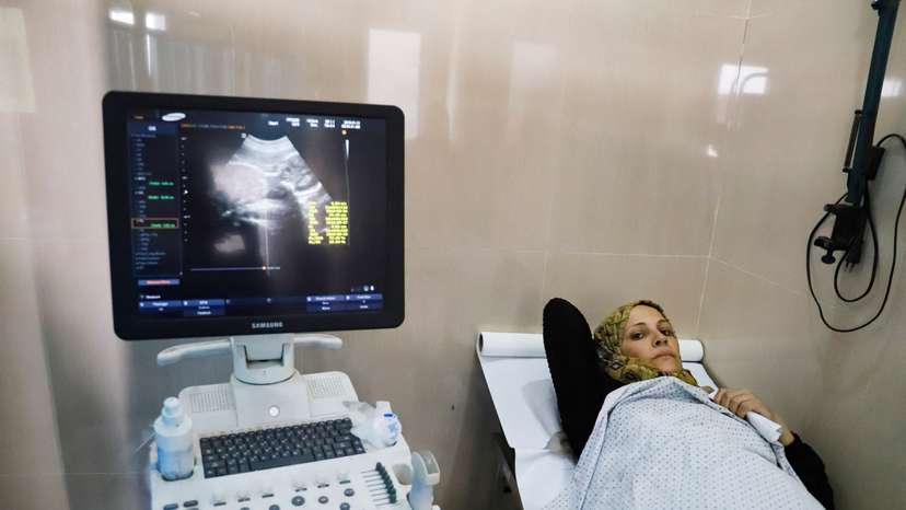 Fatima Arafa, a pregnant and displaced Palestinian woman, undergoes medical check up at Al-Helou hospital, in Gaza City