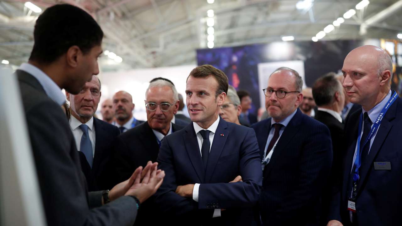 FILE PHOTO: French President Emmanuel Macron visits a stand at Euronaval, the world naval defence exhibition in Le Bourget near Paris