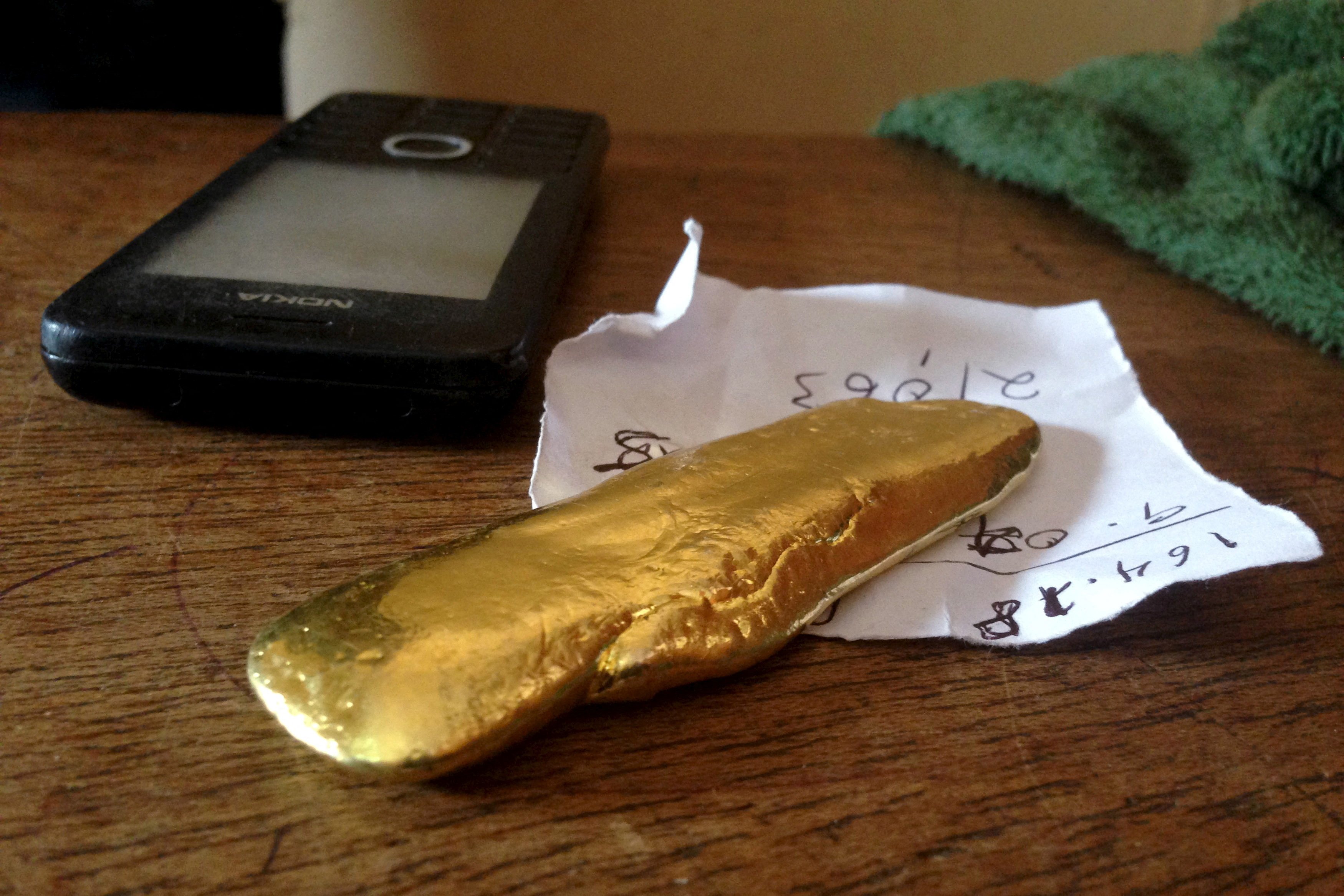 FILE PHOTO: A brick of gold is seen on an artisanal trader's desk in Tarkwa