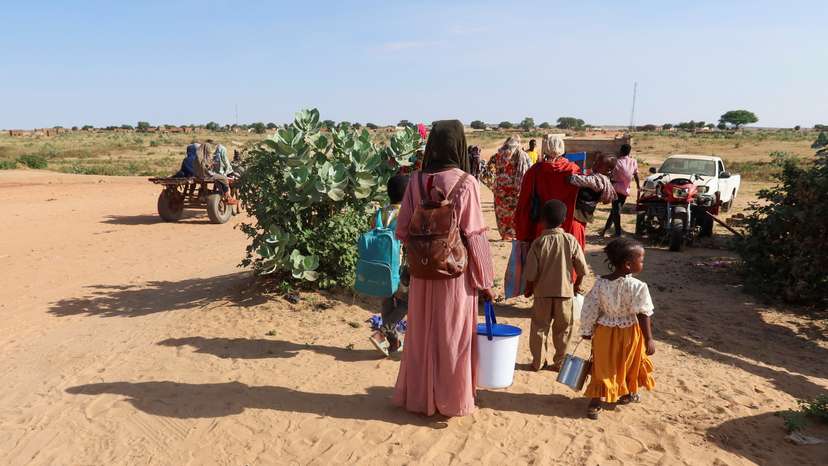 Women look at the border, hoping that their relatives reach Chad to escape death as they wait for them in Chad