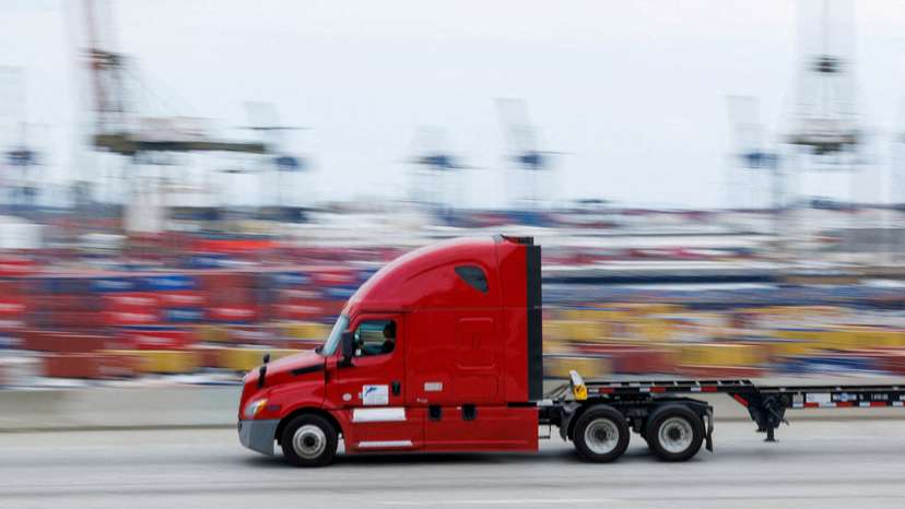 FILE PHOTO: FILE PHOTO: Semi-truck drives past Chinese shipping containers at the Port of Los Angeles