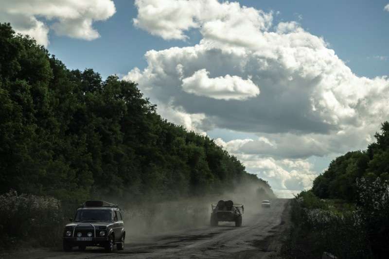 Ukrainian service members ride an Armoured Personnel Carrier near the Russian border in Sumy region