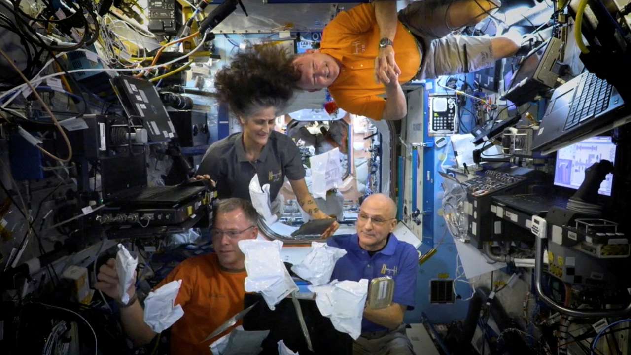 FILE PHOTO: NASA astronauts on ISS unbox Thanksgiving meals in space