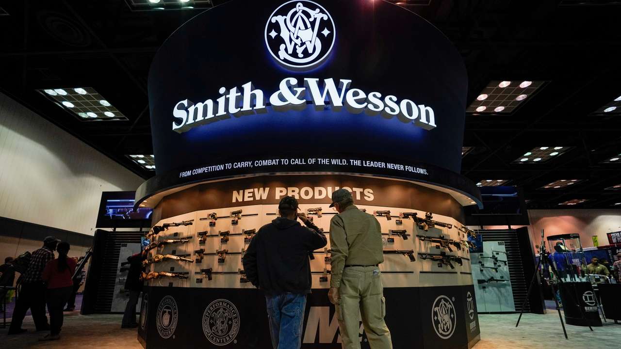 FILE PHOTO: Attendees inspect Smith & Wesson rifles at the National Rifle Association's (NRA) annual meeting in Indianapolis, Indiana