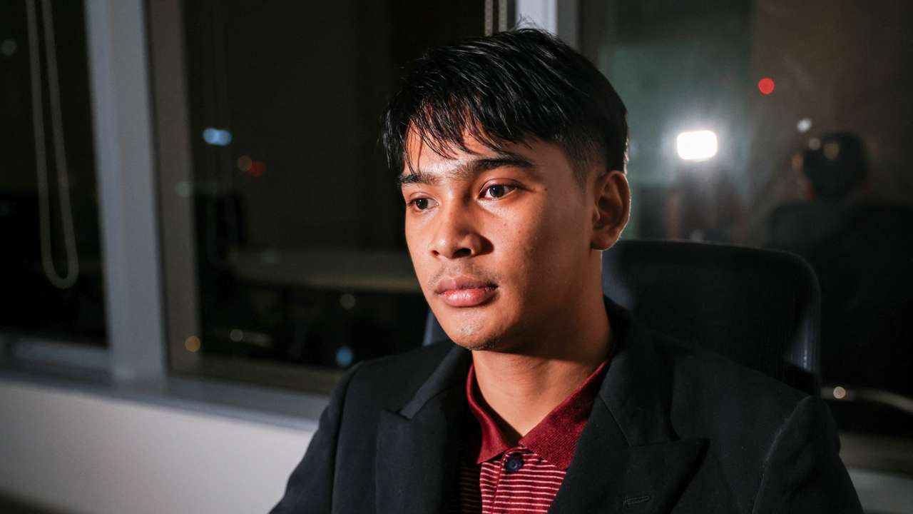 Louis, a Thai victim of scam centers who was trafficked into working in Cambodia, looks on during an interview with Reuters, in Bangkok