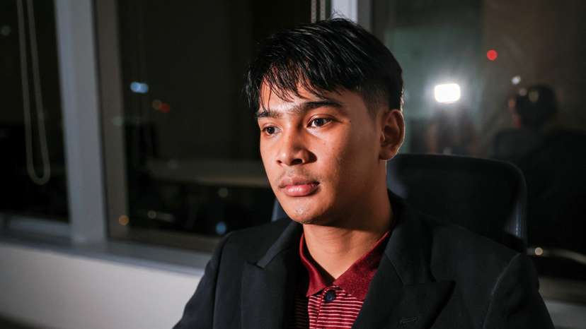 Louis, a Thai victim of scam centers who was trafficked into working in Cambodia, looks on during an interview with Reuters, in Bangkok