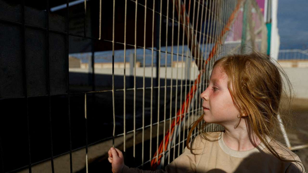 Palestinians with dual citizenship wait outside the Rafah border crossing with Egypt in the hope of getting permission to leave Gaza, amid the ongoing Israeli-Palestinian conflict, in Rafah