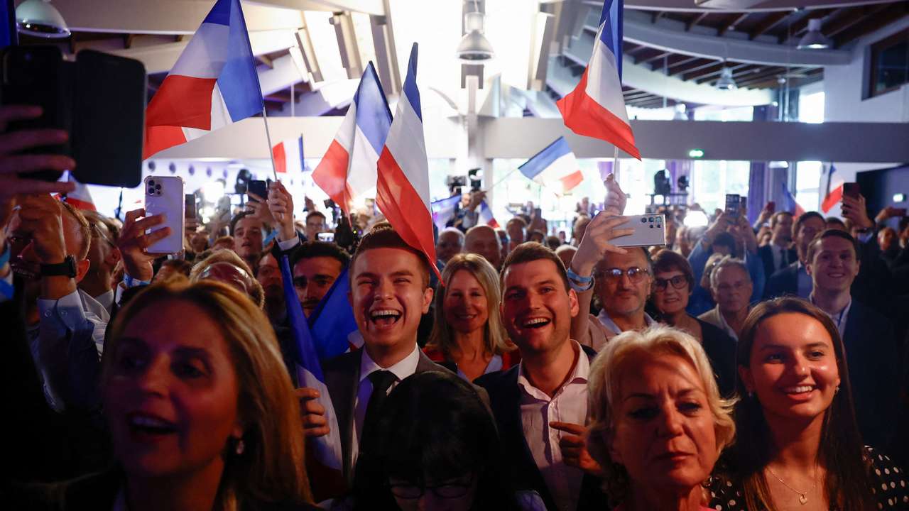 Far-right National Rally (Rassemblement National - RN) party members react after the polls closed during the European Parliament elections, in Paris